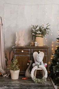Christmas decor in the children's room, toys, a tree in a pot, a christmas wreath and lights