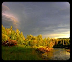 Scenic view of lake against cloudy sky