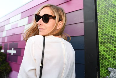 Portrait of woman wearing sunglasses standing outdoors