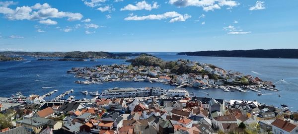 High angle view of townscape by sea against sky