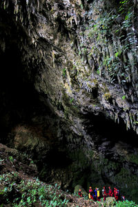 Group of people on rock in cave