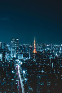 Illuminated cityscape against sky at night