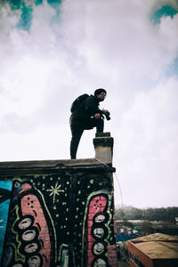 Man working against sky