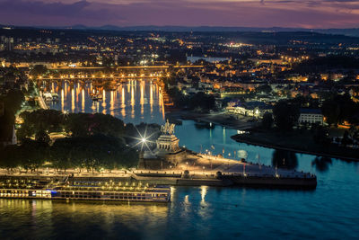 High angle view of river in illuminated city at night