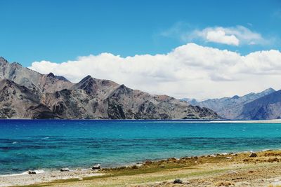 Scenic view of mountains against cloudy sky