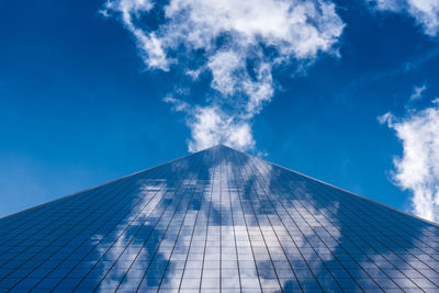 Low angle view of modern building against blue sky