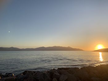 Scenic view of sea against clear sky during sunset