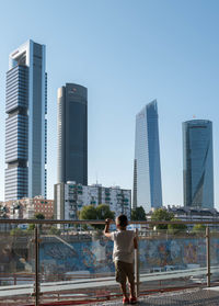 Rear view of man standing in city 