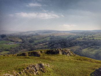 Scenic view of landscape against cloudy sky