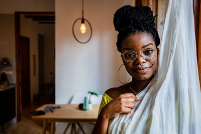 Portrait of smiling young woman at home