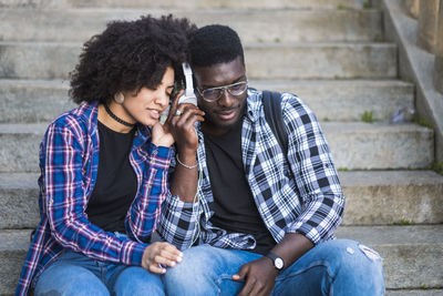 Young couple sitting on staircase