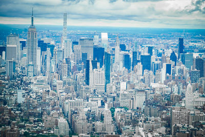 Aerial view of modern buildings in city against sky