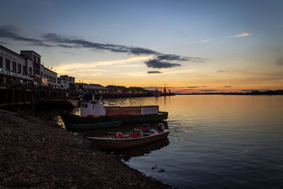 Scenic view of river against sky at sunset