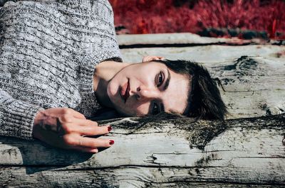 Young woman lying on wooden bench