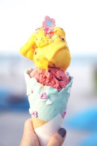 Close-up of hand holding ice cream cone