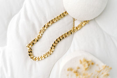 High angle view of necklace on white background