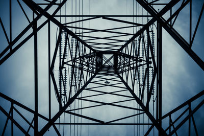 Low angle view of silhouette electricity pylon against sky