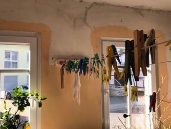 Clothes drying on wall by window at home