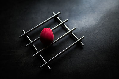 Close-up of red bell over black background