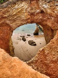 Scenic view of sea seen through arch