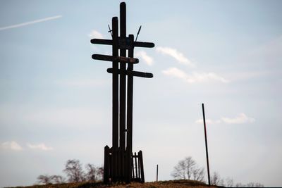 Low angle view of silhouette cross against sky during sunset