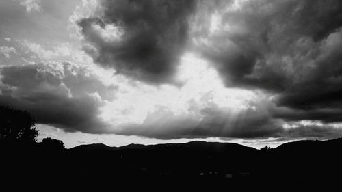 Silhouette landscape against sky