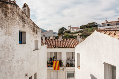 Residential buildings against cloudy sky