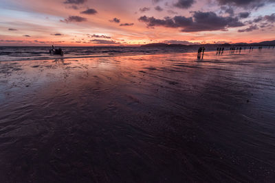 Scenic view of beach against sky during sunset