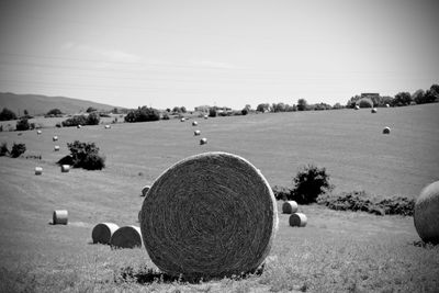 Hay bales on field against sky