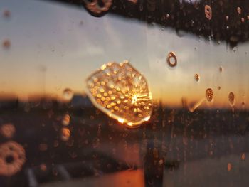 Close-up of wet glass window during rainy season