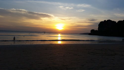 Scenic view of beach against sky during sunset