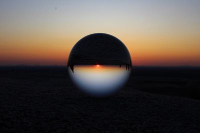 Silhouette landscape against clear sky during sunset