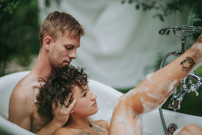 Couple in bathtub outdoors