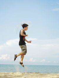 Full length of man on beach against sky