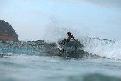 Surfer on a wave, lombok, indonesia