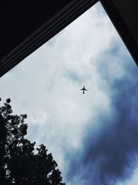 Low angle view of train against cloudy sky