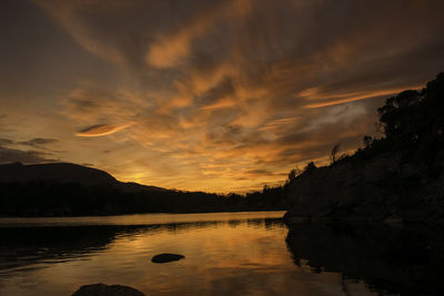 Scenic view of silhouette mountains against sky at sunset