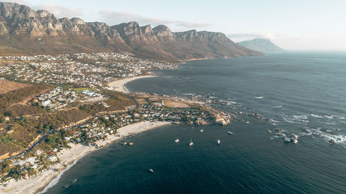 Scenic view of sea and mountains against sky