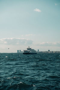 Ship sailing on sea against sky