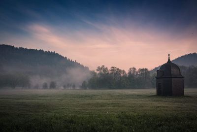 Scenic view of field against sky during foggy weather