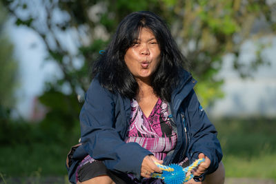 Portrait of woman sitting outdoors