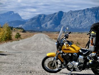 Motorcycle on footpath against mountains