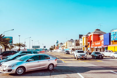 Cars on street against buildings in city