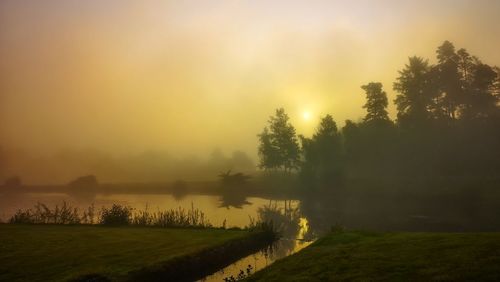 Scenic view of lake against sky during sunset