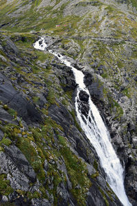 High angle view of waterfall amidst rocks