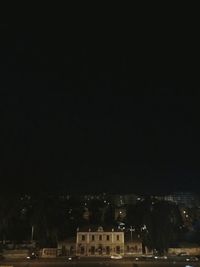 Illuminated cityscape against sky at night