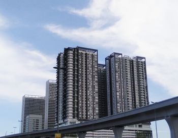 Low angle view of modern buildings against sky in city