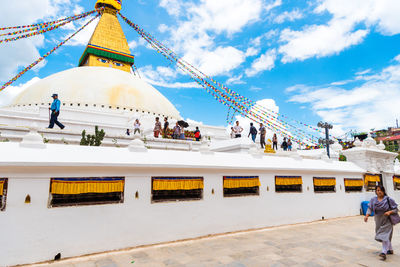 People at temple against building