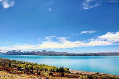 Scenic view of calm lake against cloudy sky