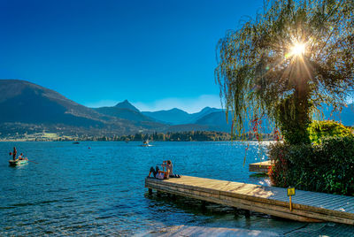 Scenic view of lake against clear blue sky